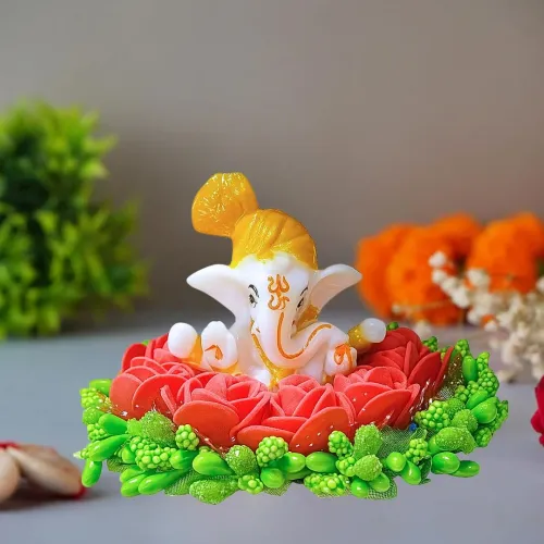 Lord Ganesha Idol on Decorative Plate with Red Roses and Green Floral Accents
