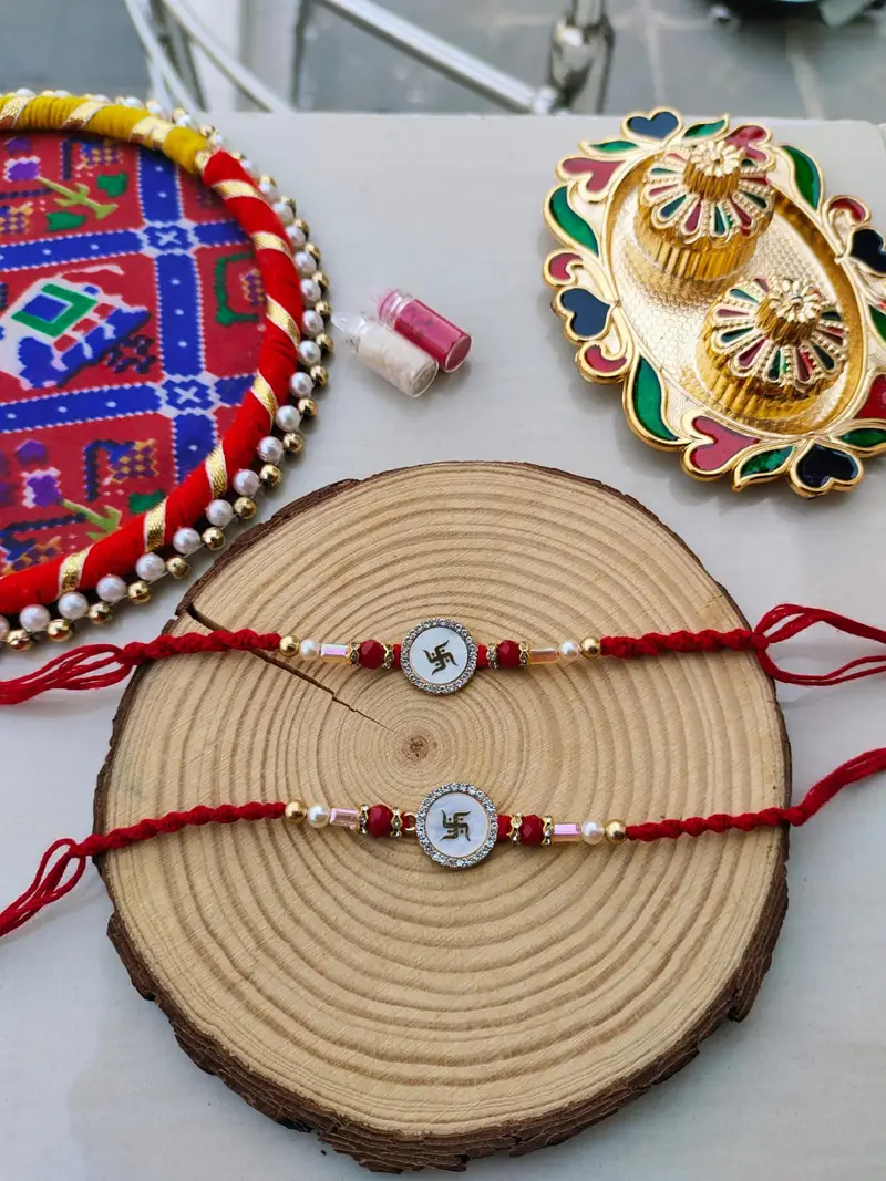 Auspicious White Enamel Swastik Designer Rakhi Collection (2Pcs) product image